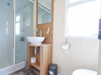 a bathroom with a sink and a shower at Bluebird in Clacton-on-Sea