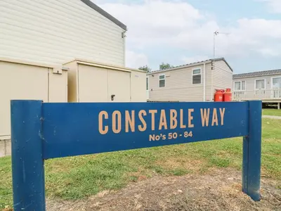 a blue street sign in front of a house at Bluebird in Clacton-on-Sea