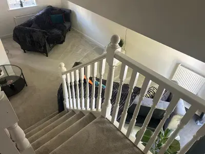 a staircase in a living room with a bed at Upto 9 Contractors, LongStay Discounts in Hythe