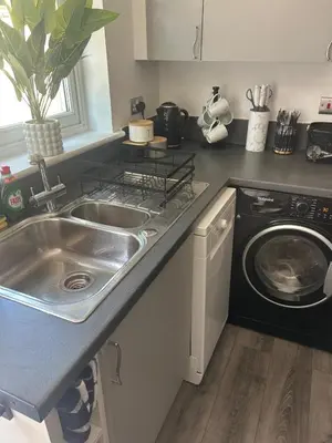 a kitchen with a sink and a washing machine at Upto 9 Contractors, LongStay Discounts in Hythe