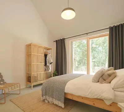 a bedroom with a bed and a large window at The Church Hall in Ipswich