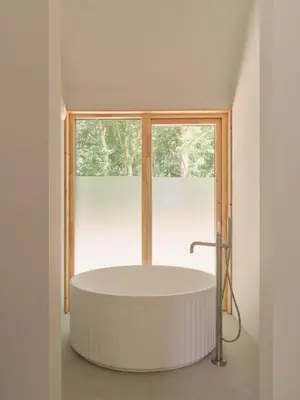 a bath tub in a room with a window at The Church Hall in Ipswich