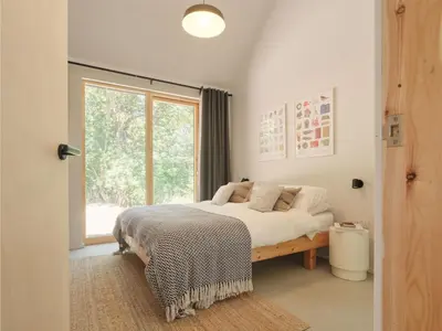 a bedroom with a large bed and a window at The Church Hall in Ipswich