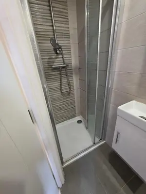a shower with a glass door in a bathroom at ELY Stay in Ipswich