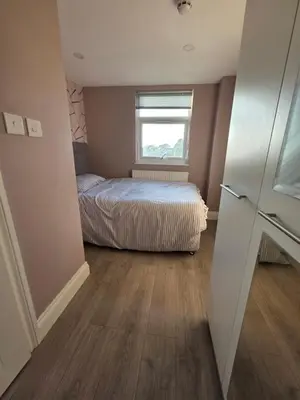 a small bedroom with a bed and a window at ELY Stay in Ipswich
