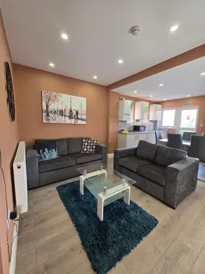a living room with two couches and a table at ELY Stay in Ipswich