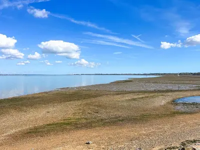 a large body of water with a rocky shore at Thirslet in Maldon