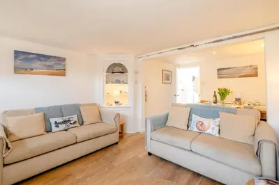a living room with two couches and a table at Seahorse Cottage, Aldeburgh - sleeps 4 - Adult only property - Managed by Aldeburgh Coastal Cottages in Aldeburgh