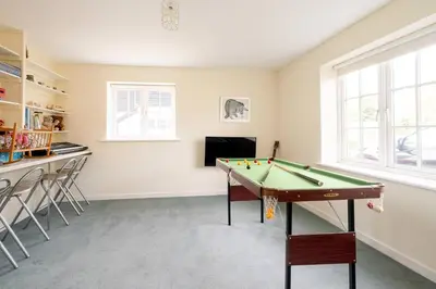 a room with a pool table and a bar at Claysmead - A large Lakeside House in Thorpeness - Aldeburgh Coastal Cottages in Thorpeness