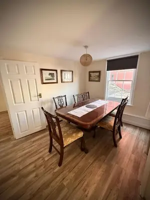 a dining room with a wooden table and chairs at Churchgate Apartment in Bury Saint Edmunds