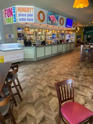 a fast food restaurant with a chair and a counter at Hadleigh Caravans at Seawick Clacton in Clacton-on-Sea