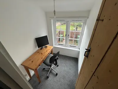 an office with a desk with a computer and a chair at Harleston Norfolk Suffolk border Historic Cottage in Harleston