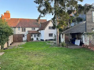 a group of white houses with a yard at Harleston Norfolk Suffolk border Historic Cottage in Harleston