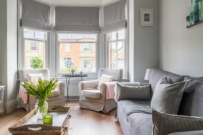 a living room with a couch and chairs and windows at Danes House 4 in Aldeburgh