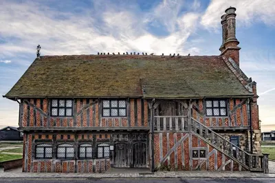 an old building with birds perched on top of it at Danes House 4 in Aldeburgh