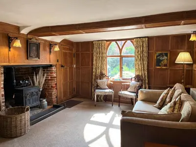 a living room with a couch and a fireplace at Little rooms at The Cottage in Bishops Stortford