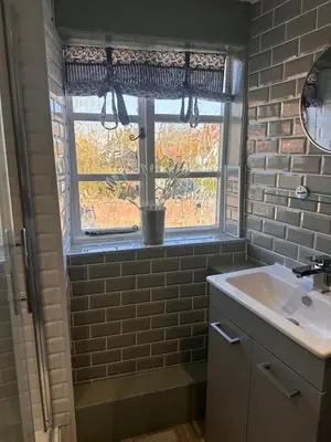 a bathroom with a sink and a window at 2 Bedroom Cottage in Debenham - The Old Toll House in Debenham