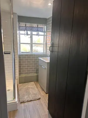 a small bathroom with a sink and a window at 2 Bedroom Cottage in Debenham - The Old Toll House in Debenham