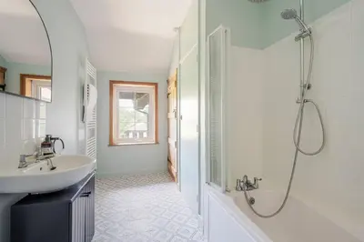 a white bathroom with a shower and a sink at Boutique Suffolk Cottage Cosy Family Holiday Home with Garden Near Aldeburgh in Kettleburgh