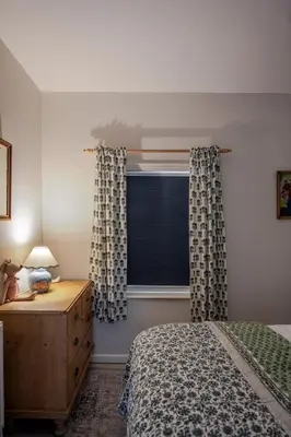 a bedroom with a bed and a window with curtains at Boutique Suffolk Cottage Cosy Family Holiday Home with Garden Near Aldeburgh in Kettleburgh