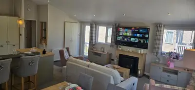 a living room with a couch and a fireplace at The Pink Lady in Walton-on-the-Naze