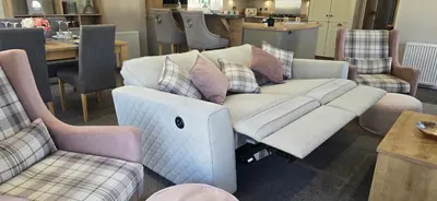a living room with a couch with a laptop on it at The Pink Lady in Walton-on-the-Naze
