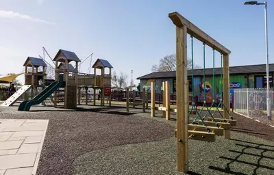 a row of playground equipment in a park at The Pink Lady in Walton-on-the-Naze
