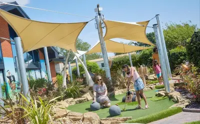 a group of people playing in a garden at The Pink Lady in Walton-on-the-Naze