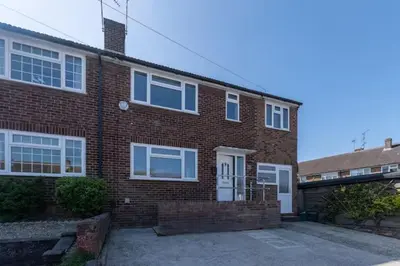 a brick house with a white door and windows at Stylish and comfortable 4-Bedroom Retreat in the Heart of Chelmsford in Chelmsford