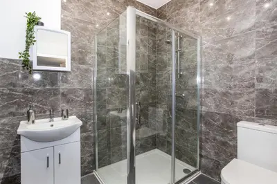 a bathroom with a shower and a sink at Stylish & Modern Home by the Sea Near Three Shells in Southend-on-Sea
