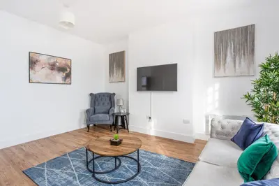 a living room with a couch and a tv at 3 Bed Apartment with Balcony in Southend on Sea! in Southend-on-Sea
