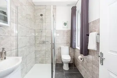 a bathroom with a shower and a toilet and a sink at 3 Bed Apartment with Balcony in Southend on Sea! in Southend-on-Sea