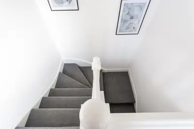 a staircase in a house with grey stairs at 3 Bed Apartment with Balcony in Southend on Sea! in Southend-on-Sea