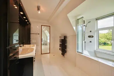 a large bathroom with a sink and a shower at The Flat - Waresley Park Estate