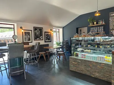a restaurant with a counter and tables and chairs at The Flat - Waresley Park Estate