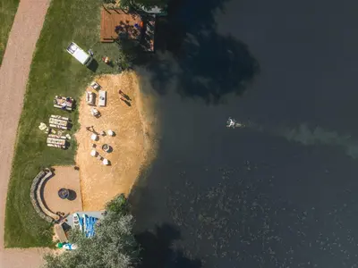 an aerial view of a beach with chairs and the water at The Flat - Waresley Park Estate