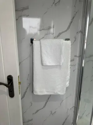 a towel hanging on a towel rack in a bathroom at A Lovely and Cosy Studio Apartment in Navestock