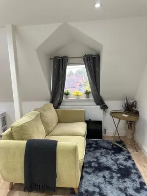 a living room with a couch and a window at A Lovely and Cosy Studio Apartment in Navestock