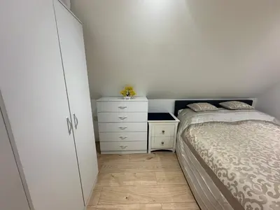 a small bedroom with a bed and a dresser at A Lovely and Cosy Studio Apartment in Navestock