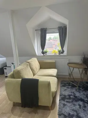 a living room with a couch and a window at A Lovely and Cosy Studio Apartment in Navestock