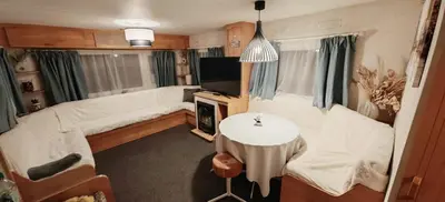 a living room with a couch and a table at Dancing Seagulls Caravan in Clacton-on-Sea