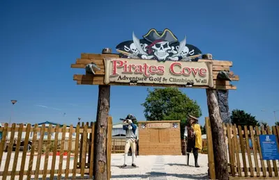 a person taking a picture of a sign at a pirates cove at Dancing Seagulls Caravan in Clacton-on-Sea