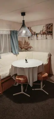 a room with a table and a bed and a couch at Dancing Seagulls Caravan in Clacton-on-Sea