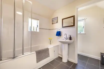a bathroom with a shower and a sink and a tub at 3 Bed in Stowupland oc-p32216 in Stowmarket