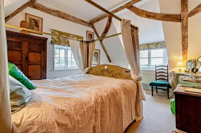 a bedroom with a bed in a room with beams at 4 Bed in Sudbourne oc-w32267 in Sudbourne