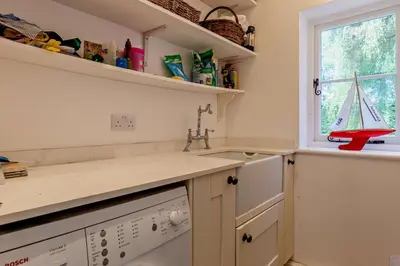 a kitchen with a sink and a dishwasher at 4 Bed in Sudbourne oc-w32267 in Sudbourne