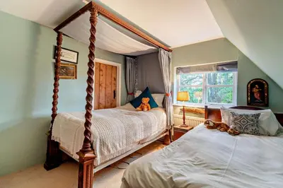 a bedroom with two beds and a teddy bear on the bed at 4 Bed in Sudbourne oc-w32267 in Sudbourne
