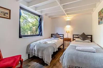 two beds in a room with a window at 2 Bed in Sudbourne oc-w32264 in Sudbourne