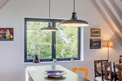 a kitchen with two pendant lights and a window at 2 Bed in Sudbourne oc-w32264 in Sudbourne