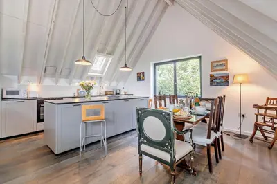 a kitchen and dining room with a table and chairs at 2 Bed in Sudbourne oc-w32264 in Sudbourne